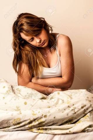 Woman feeling sick with stomachache in bed - Pain in stomach